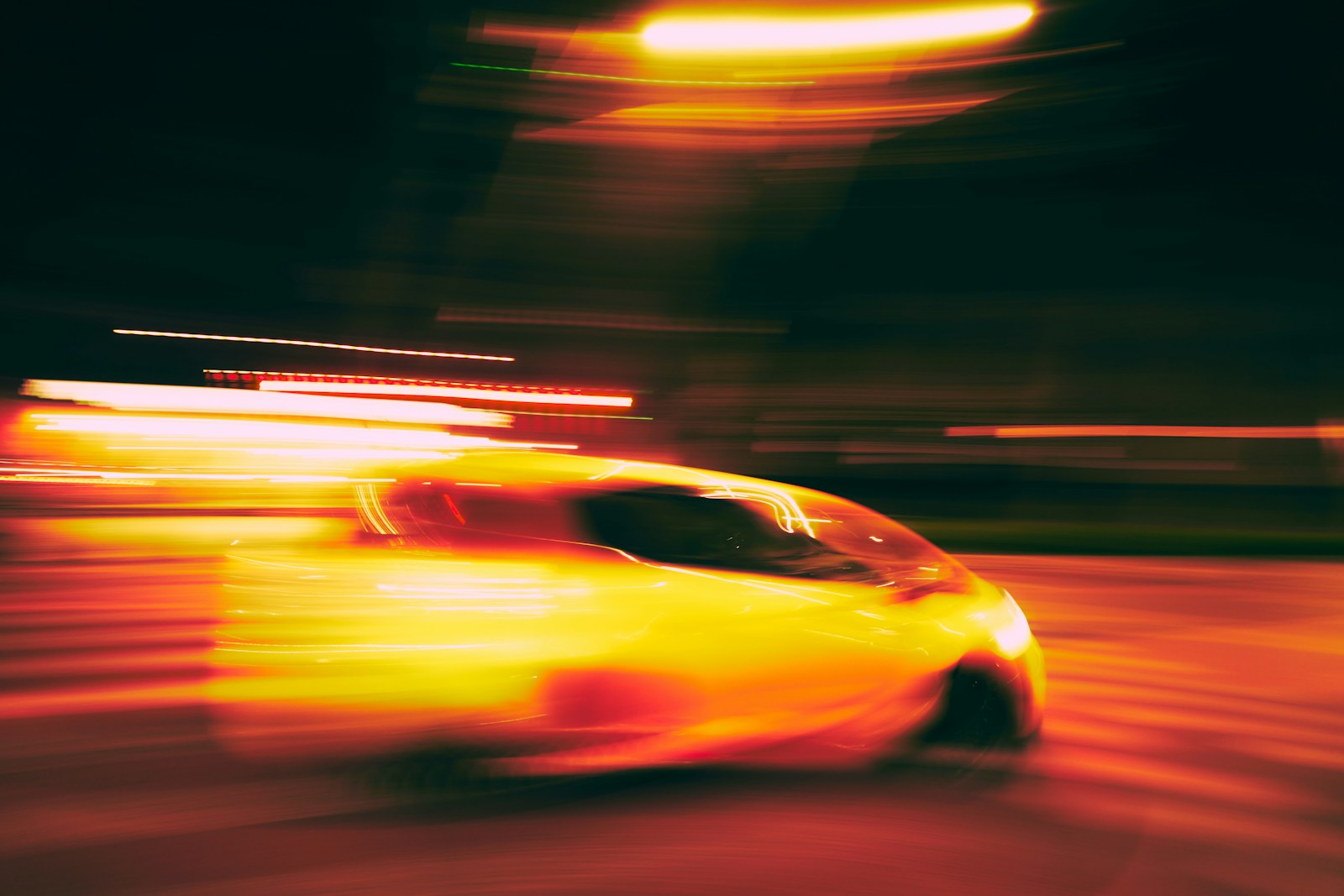 a blurry photo of a yellow sports car