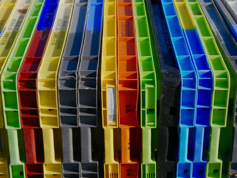 a bunch of different colored plastic containers stacked on top of each other