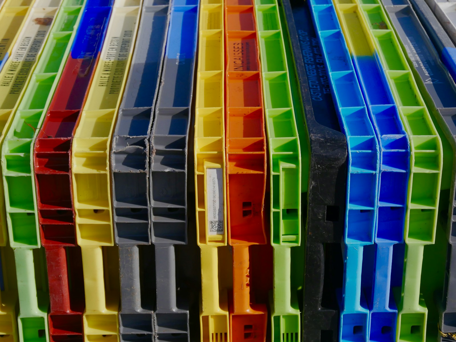 a bunch of different colored plastic containers stacked on top of each other