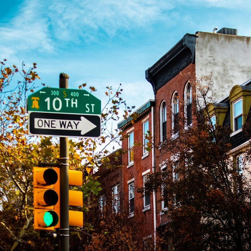 a green traffic light sitting next to a tall building
